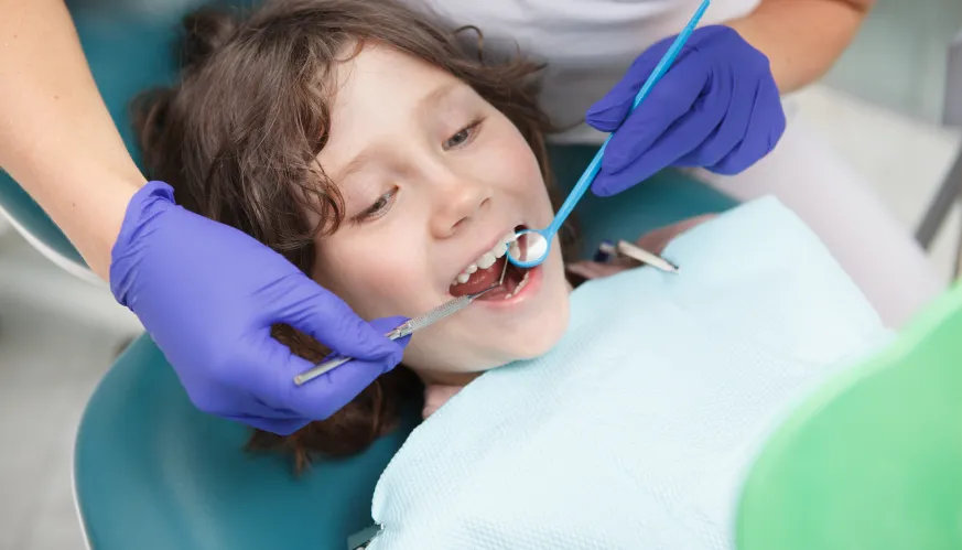 niño en la consulta del dentista de Sanitas durante una revisión
